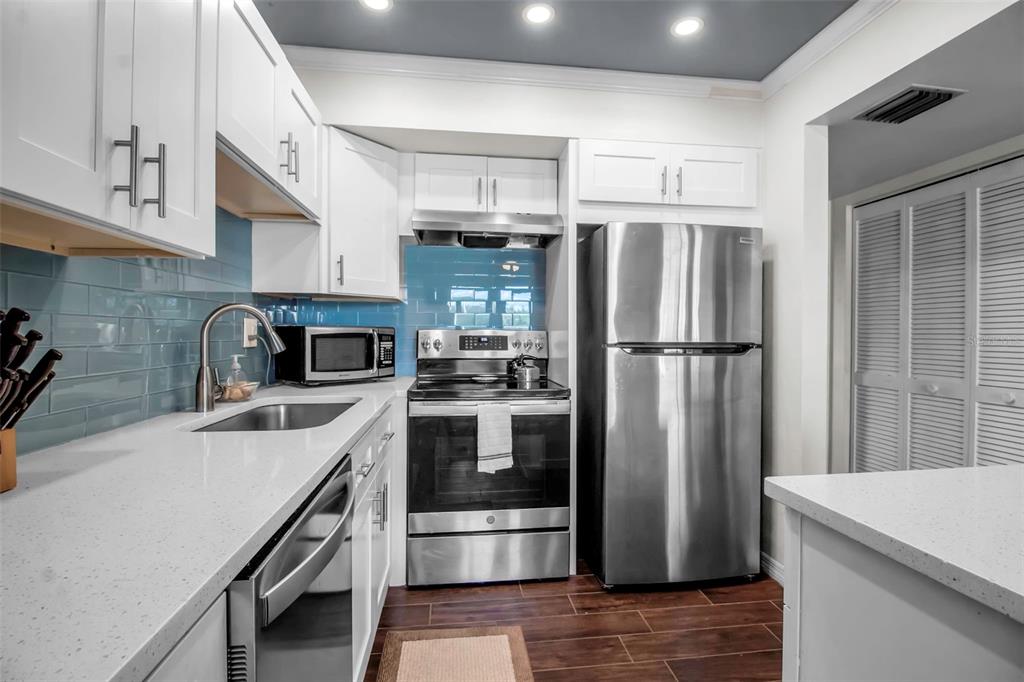 5420 Swift Road, Unit 38 Sarasota, FL 34231 - Photo 6 of 37 a kitchen with stainless steel appliances a refrigerator sink and stove
