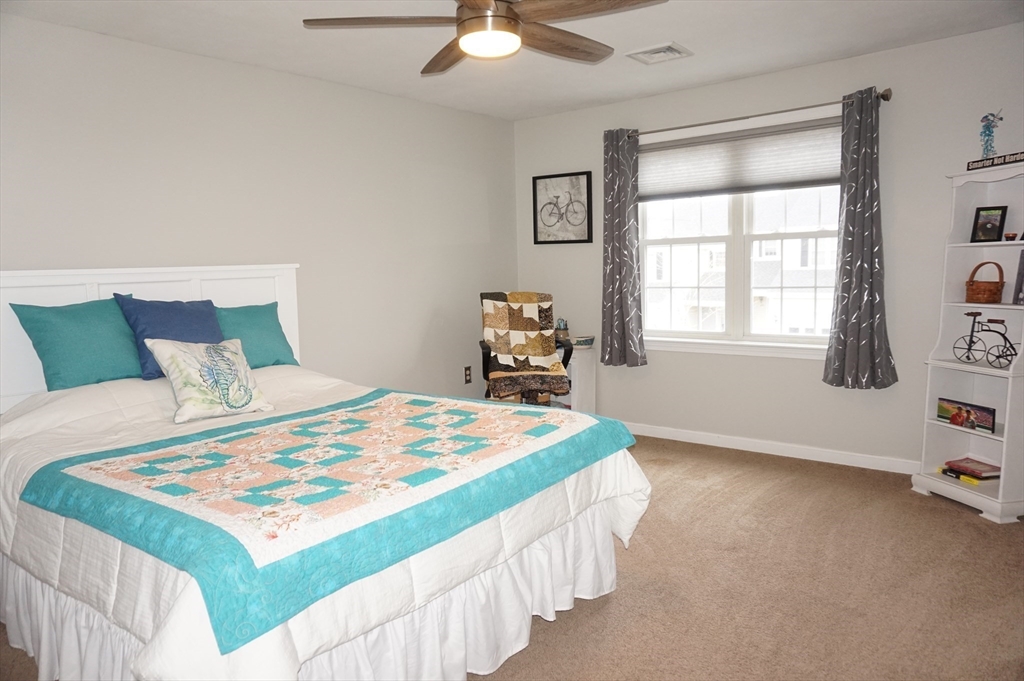 103 Bridle Cross Road, Unit 103 Fitchburg, MA 01420 - Photo 16 of 36 a bedroom with a bed and a chandelier