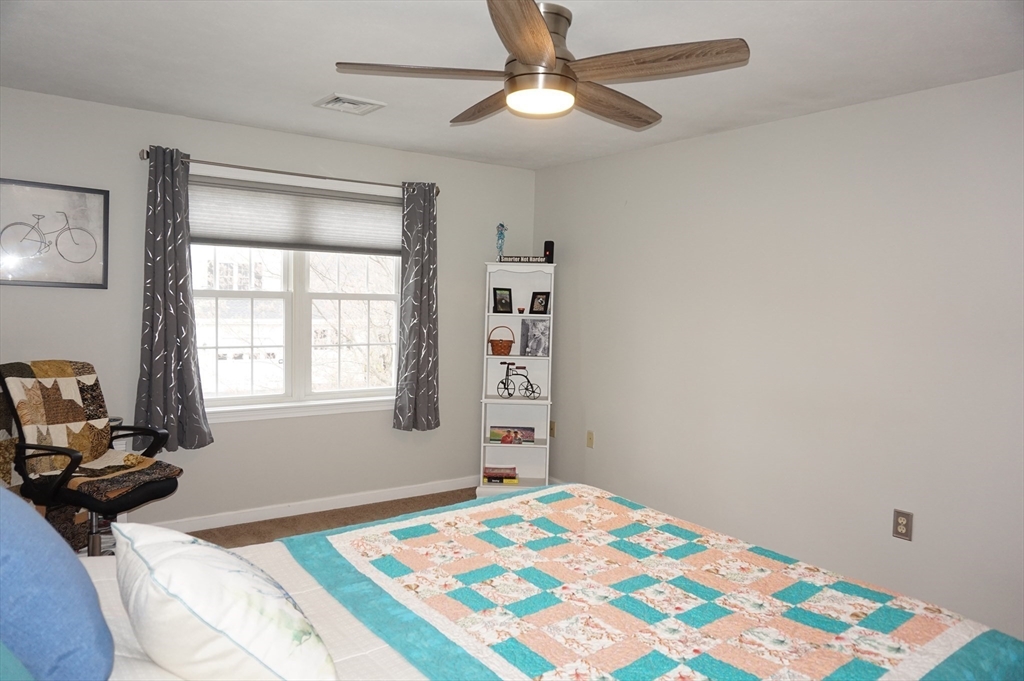 103 Bridle Cross Road, Unit 103 Fitchburg, MA 01420 - Photo 17 of 36 a bedroom with a bed dresser and a window
