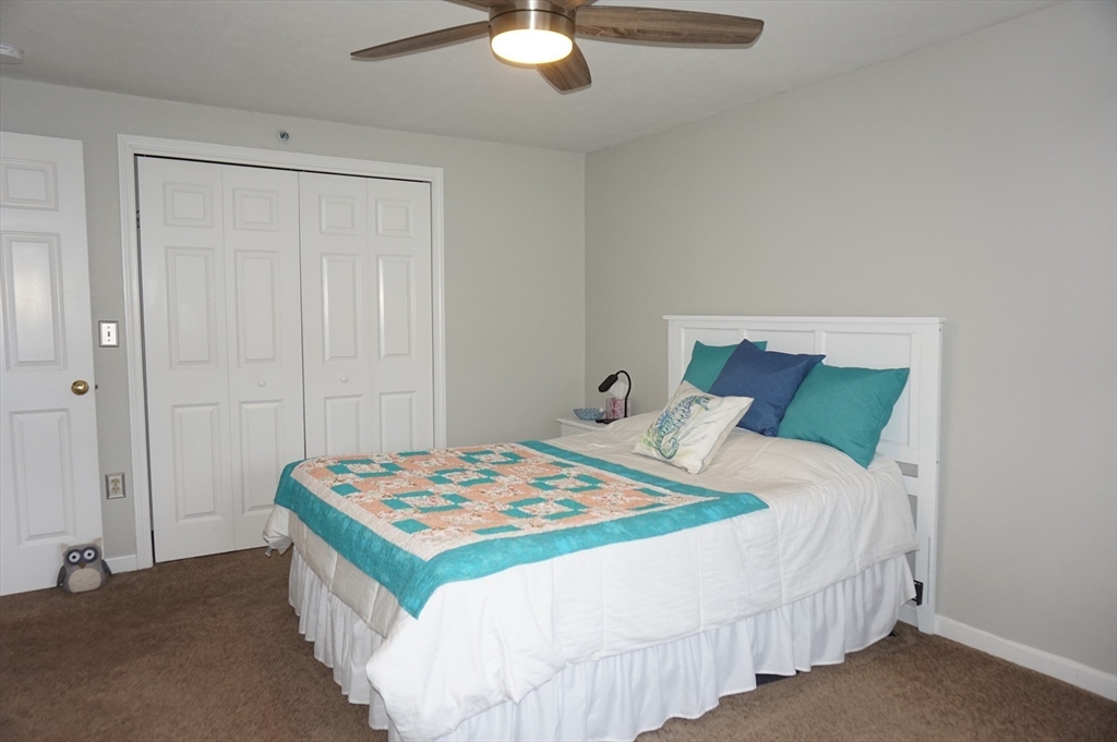 103 Bridle Cross Road, Unit 103 Fitchburg, MA 01420 - Photo 18 of 36 a bedroom with a bed and a table