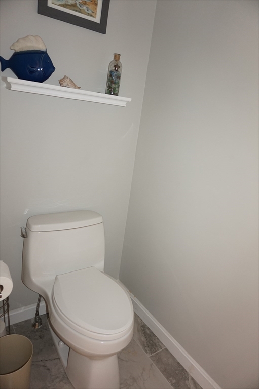 103 Bridle Cross Road, Unit 103 Fitchburg, MA 01420 - Photo 22 of 36 a white toilet sitting next to a white sink and vanity