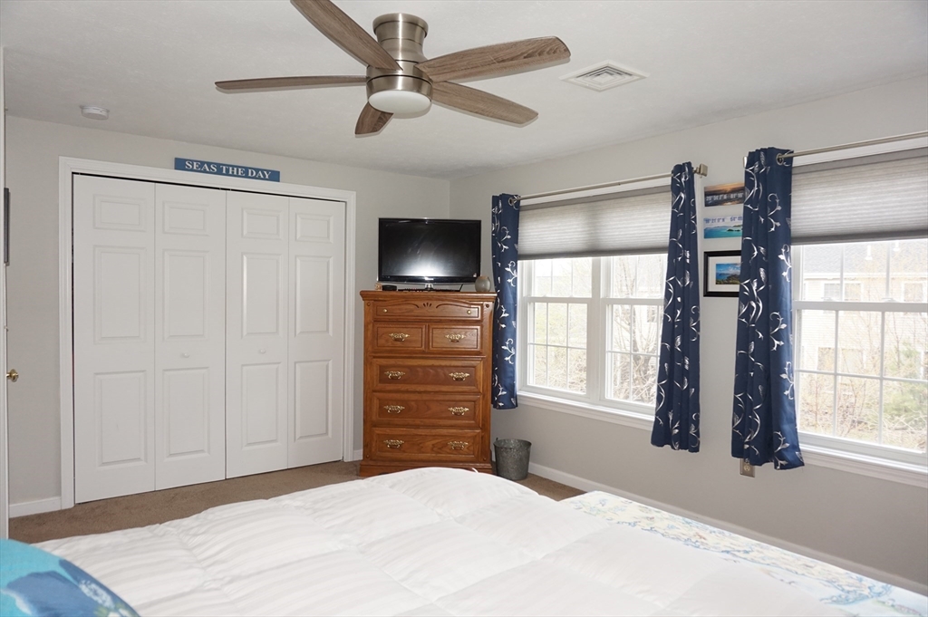 103 Bridle Cross Road, Unit 103 Fitchburg, MA 01420 - Photo 25 of 36 a bedroom with a bed and a flat screen tv