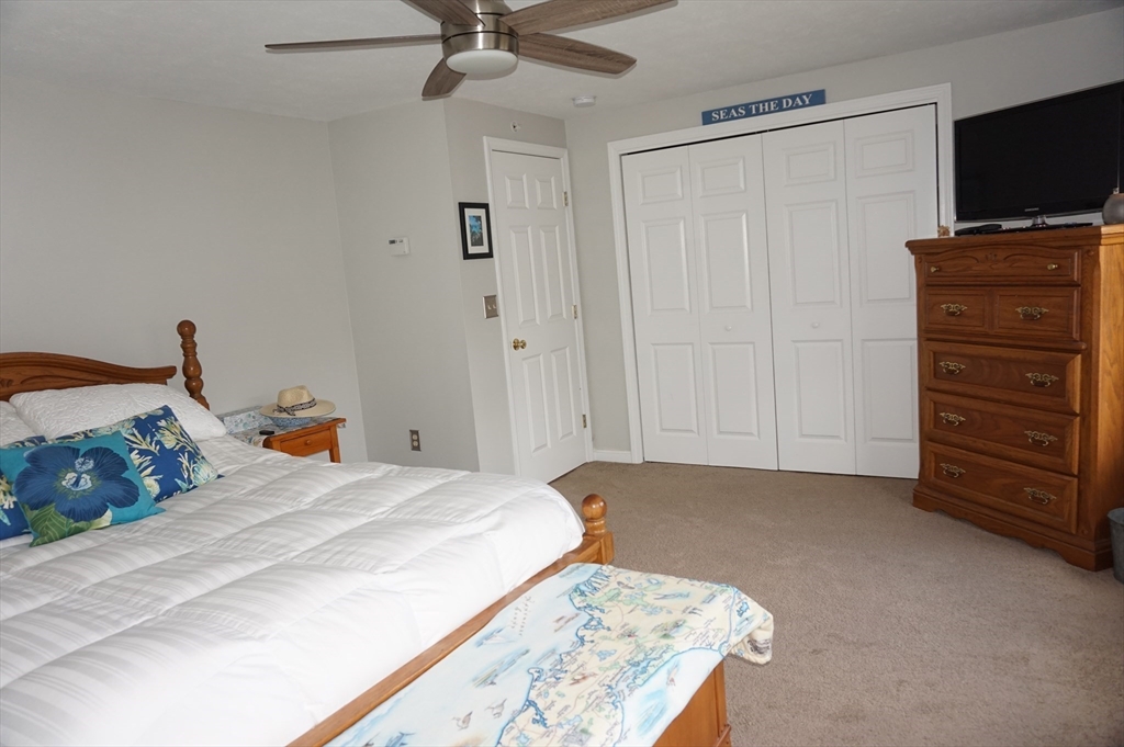 103 Bridle Cross Road, Unit 103 Fitchburg, MA 01420 - Photo 26 of 36 a bedroom with a bed and a flat screen tv