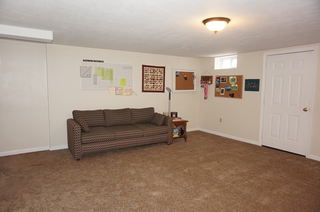 103 Bridle Cross Road, Unit 103 Fitchburg, MA 01420 - Photo 31 of 36 a living room with furniture and wall paintings