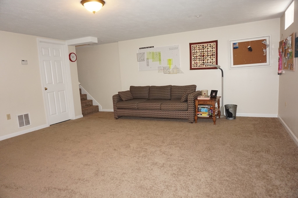 103 Bridle Cross Road, Unit 103 Fitchburg, MA 01420 - Photo 32 of 36 a living room with furniture and a window
