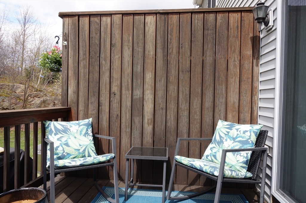 103 Bridle Cross Road, Unit 103 Fitchburg, MA 01420 - Photo 34 of 36 a balcony with table and chairs