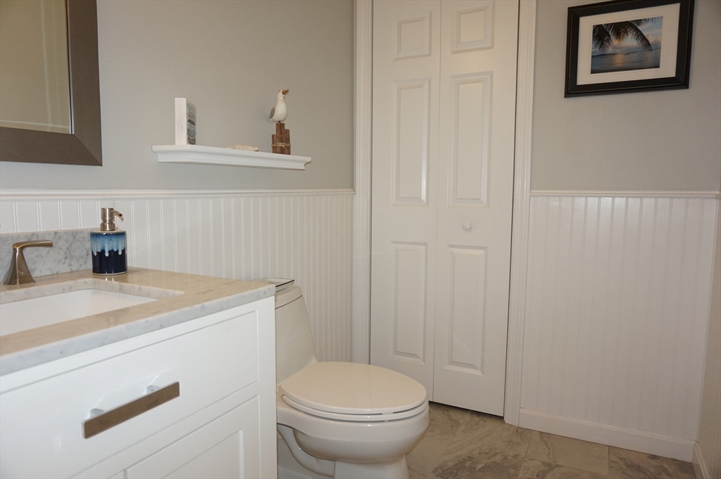 103 Bridle Cross Road, Unit 103 Fitchburg, MA 01420 - Photo 4 of 36 a bathroom with a sink a toilet and a mirror