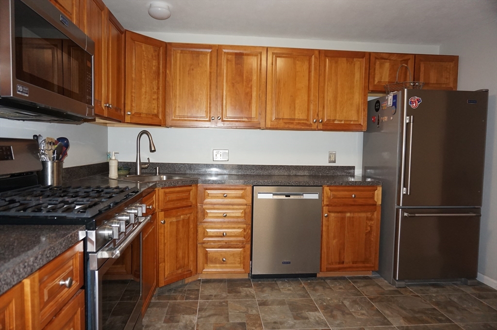 103 Bridle Cross Road, Unit 103 Fitchburg, MA 01420 - Photo 8 of 36 a kitchen with stainless steel appliances granite countertop a refrigerator stove and sink