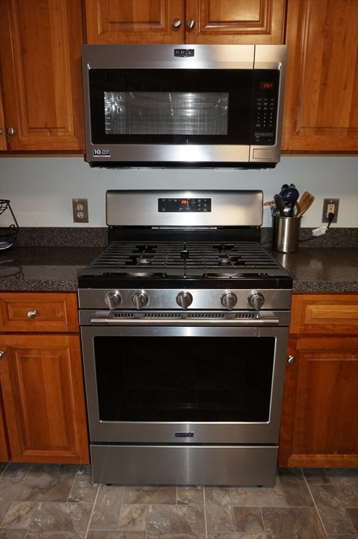 103 Bridle Cross Road, Unit 103 Fitchburg, MA 01420 - Photo 9 of 36 a stove top oven sitting inside of a kitchen