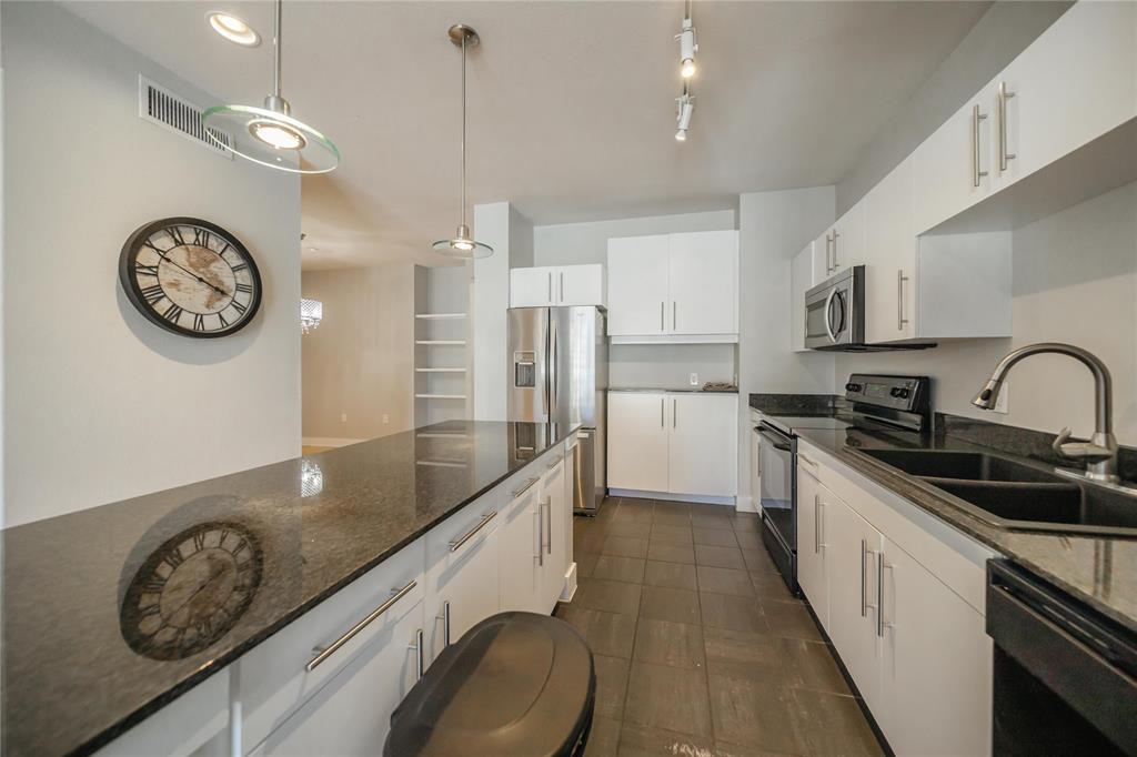 4414 Cedar Springs Road, Unit 214 Dallas, TX 75219 - Photo 7 of 29 Kitchen featuring dark stone counters, black appliances, white cabinetry, and recessed lighting