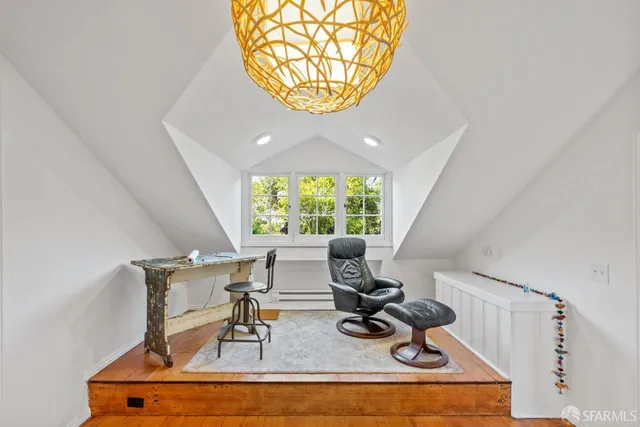 a view of a work space with furniture and a window