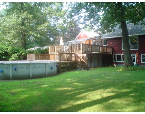 29 Broad Road Dracut, MA 01826 - Photo 4 of 16 a front view of a house with a yard and green space