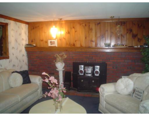 29 Broad Road Dracut, MA 01826 - Photo 9 of 16 a living room with furniture and a fireplace