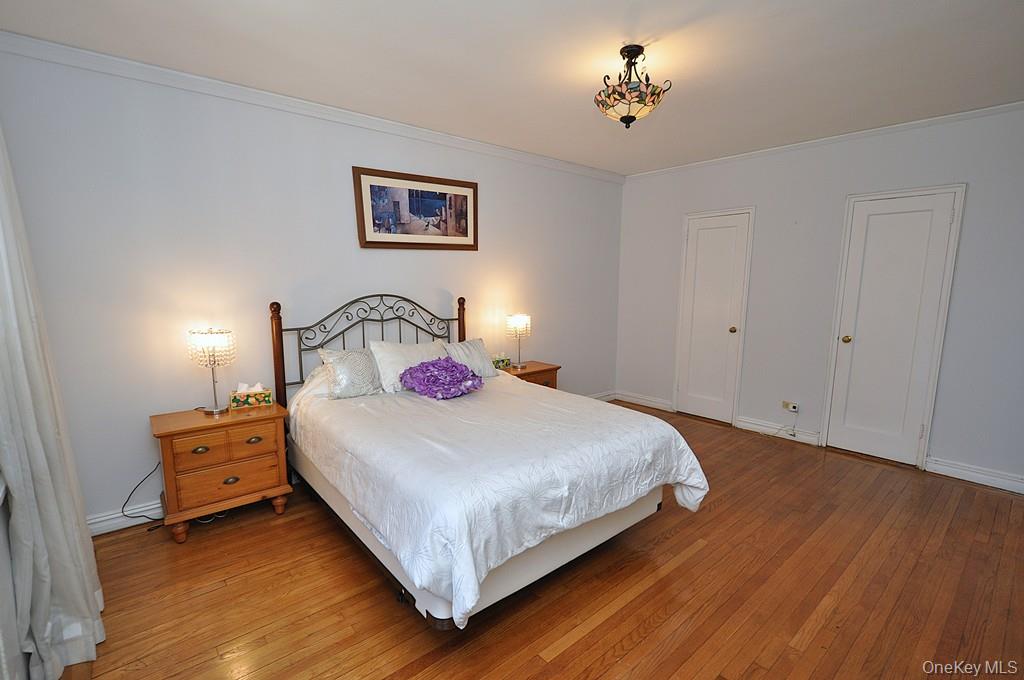 949 Palmer Road, Unit 2G Bronxville, NY 10708 - Photo 19 of 40 a bedroom with a bed and a chandelier