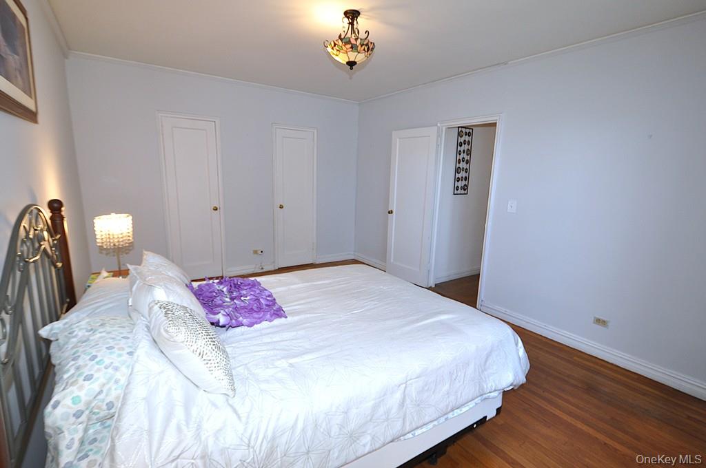 949 Palmer Road, Unit 2G Bronxville, NY 10708 - Photo 21 of 40 a bedroom with a bed and a chandelier