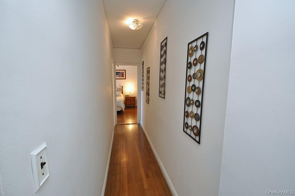949 Palmer Road, Unit 2G Bronxville, NY 10708 - Photo 29 of 40 a view of a hallway with paintings on the wall
