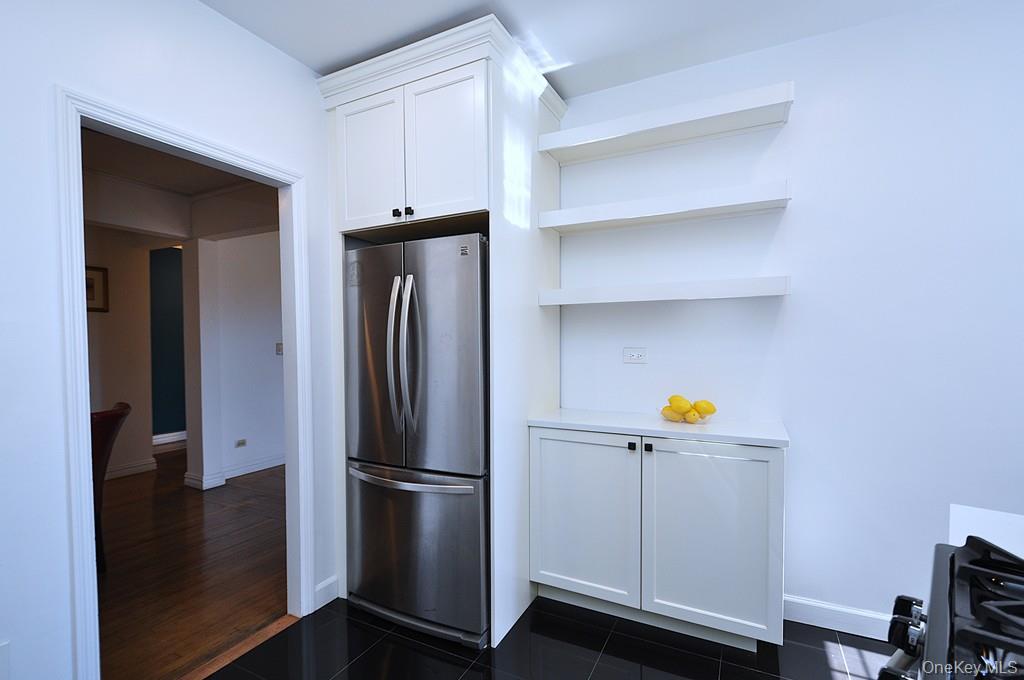 949 Palmer Road, Unit 2G Bronxville, NY 10708 - Photo 10 of 40 a kitchen with cabinets and stainless steel appliances