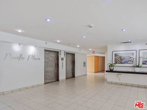 a view of a livingroom with furniture and cars