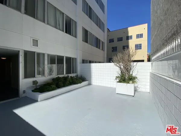 a view of white house with a yard