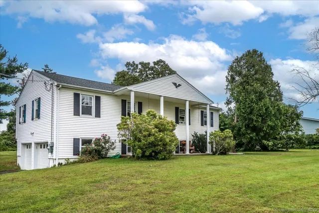 a front view of a house with a garden