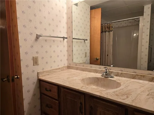 a bathroom with a shower toilet and sink
