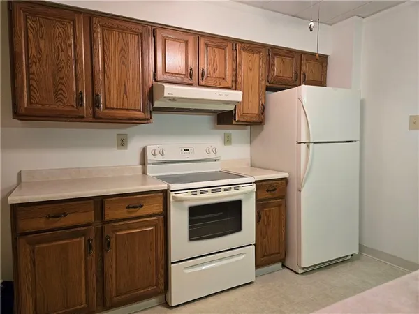 a kitchen with stainless steel appliances granite countertop a refrigerator stove a sink and dishwasher