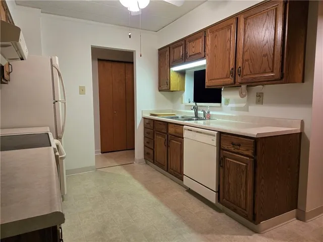 a kitchen with a sink stove and cabinets