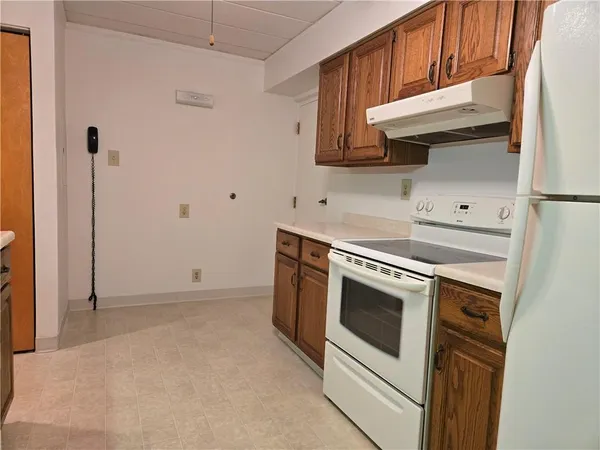 a kitchen with stainless steel appliances white cabinets and a refrigerator
