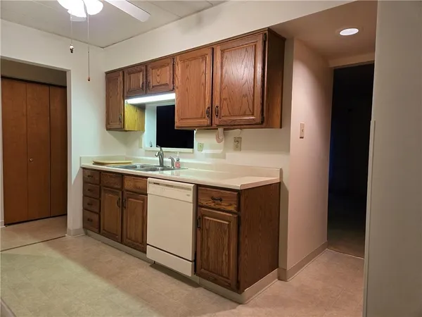 a kitchen with stainless steel appliances granite countertop a sink stove and cabinets