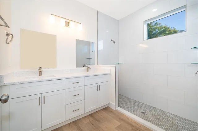 a bathroom with a double vanity sink and a mirror