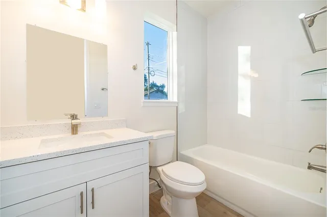 a bathroom with a sink a toilet and a bathtub