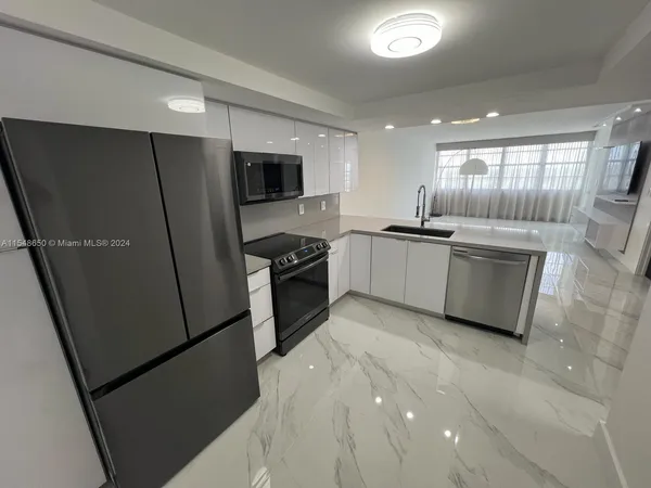 a kitchen with stainless steel appliances granite countertop refrigerator sink and cabinets