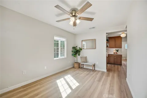 a kitchen with wooden floors and refrigerator