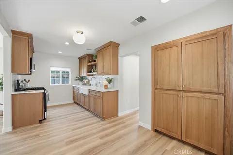 a kitchen with stainless steel appliances granite countertop a sink and a stove