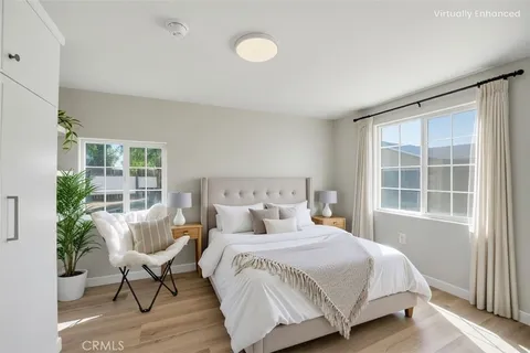 a view of a room with wooden floor lounge chair and windows