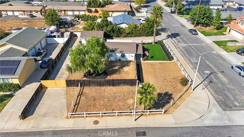 an aerial view of a house with a yard and lake view