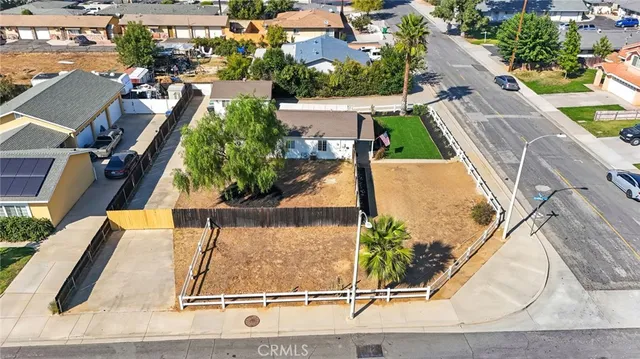 an aerial view of a house with a yard and lake view