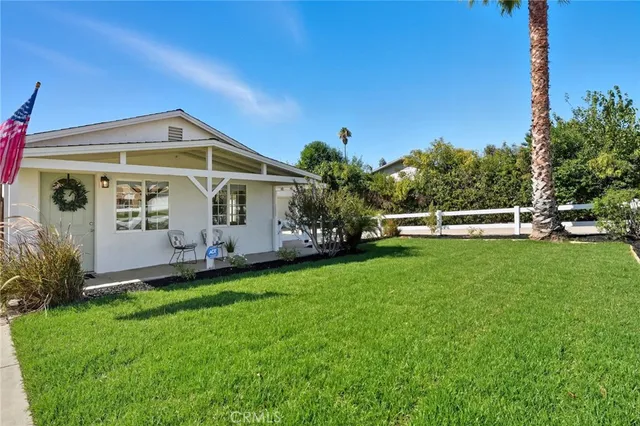 a view of a chairs and table in backyard