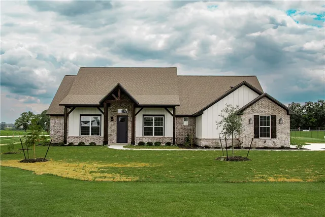 a front view of house with yard and green space