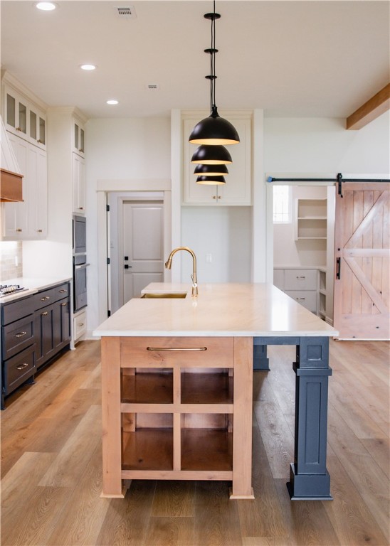 3201 Hunters Crossing Bryan, TX 77808 - Photo 12 of 33 a kitchen with kitchen island stainless steel appliances a sink center island and stove in it