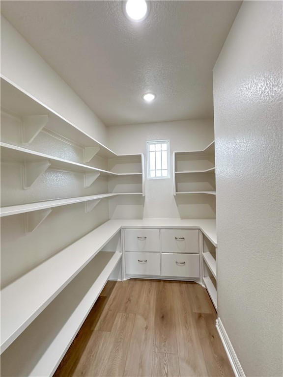 3201 Hunters Crossing Bryan, TX 77808 - Photo 14 of 33 a view of walk in closet with empty racks
