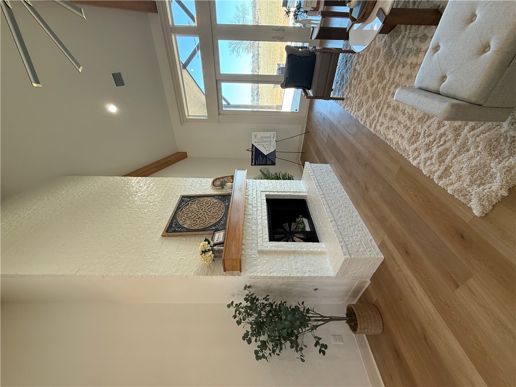 3201 Hunters Crossing Bryan, TX 77808 - Photo 31 of 40 Living room featuring wood finished floors, vaulted ceiling, a gas brick fireplace, designer ceiling fan, and recessed lighting