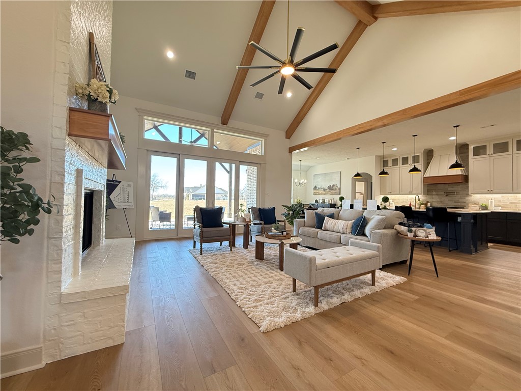 3201 Hunters Crossing Bryan, TX 77808 - Photo 33 of 40 Living room with ceiling fan, light wood-style flooring, recessed lighting, a fireplace, and vaulted ceiling