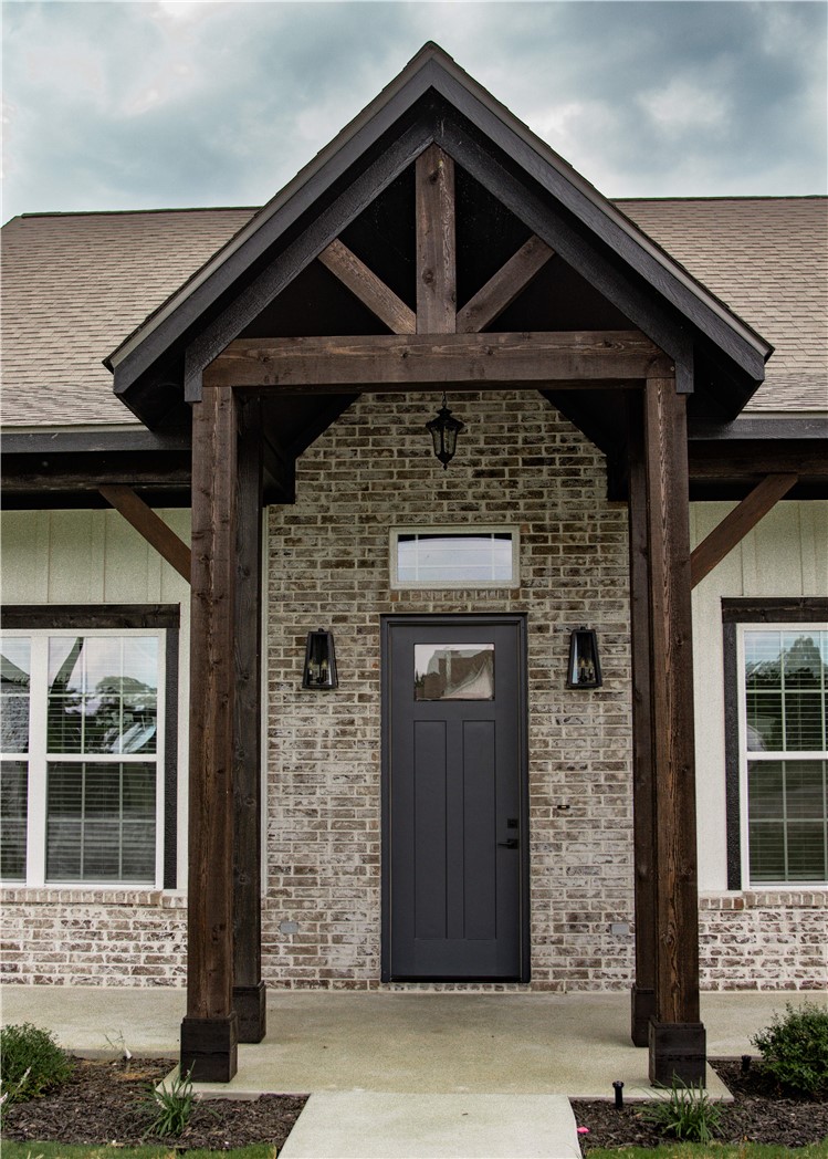 3201 Hunters Crossing Bryan, TX 77808 - Photo 4 of 40 Property entrance featuring brick siding, roof with shingles, and covered porch