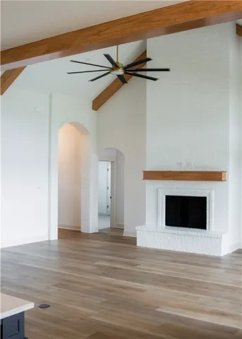 a view of a livingroom with a fireplace and wooden floor