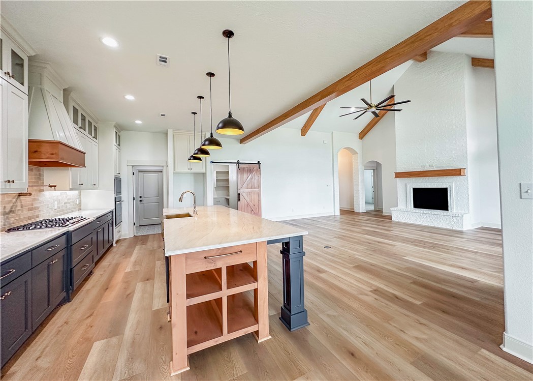 3201 Hunters Crossing Bryan, TX 77808 - Photo 33 of 33 a large kitchen with stainless steel appliances kitchen island granite countertop a sink and cabinets