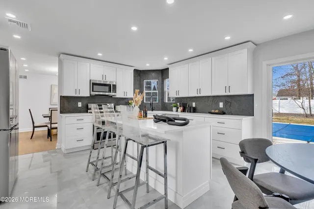 a living room with furniture and kitchen view