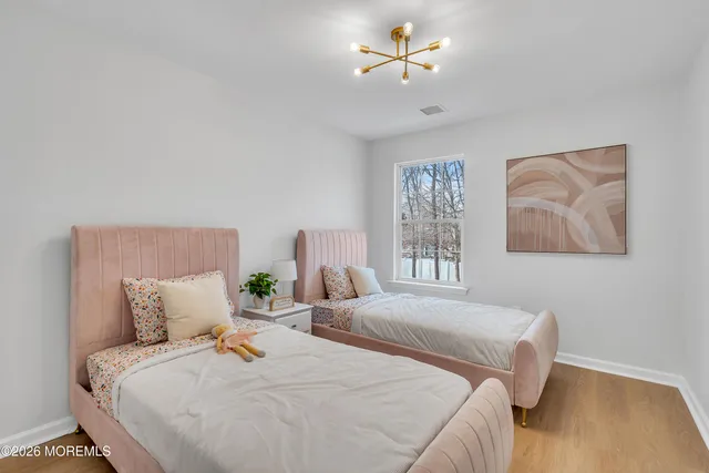 a view of a room with wooden floor and ceiling fan