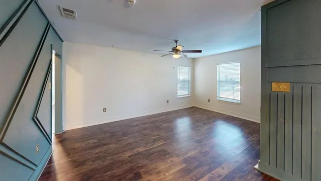 wooden floor in an empty room with a window