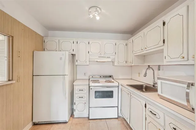 a white refrigerator freezer sitting inside of a kitchen